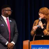 Melissa Baker-Boosamra, associate director for the Office of Student Life, introduces Albert Okwei at podium